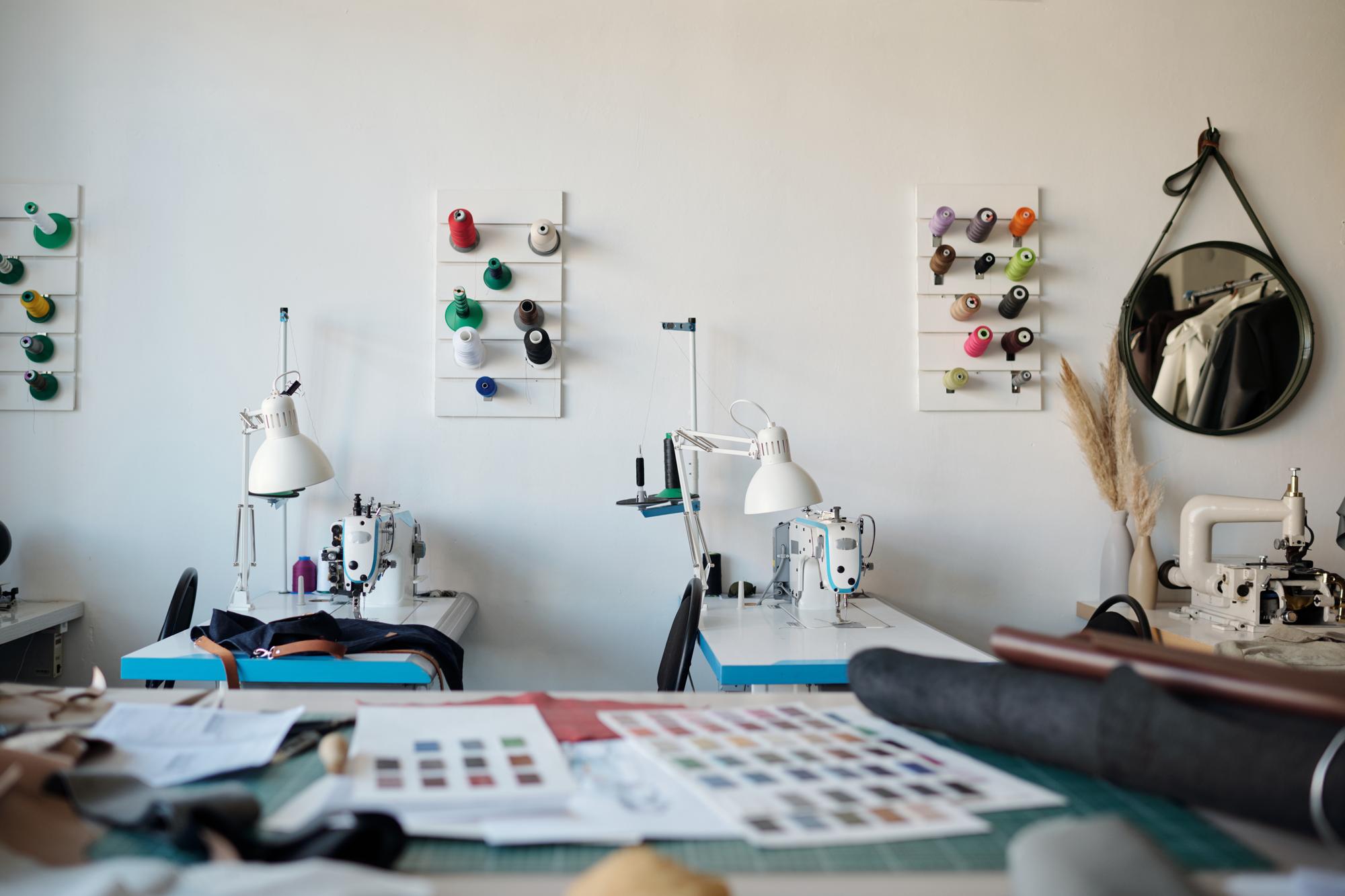 Studio workspace with embroidery machines and computer